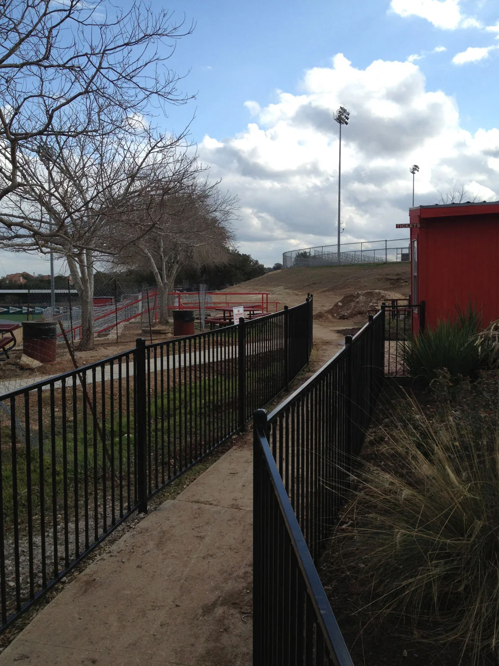 Iron fence line completed by B.C. Fence on an Austin-area property