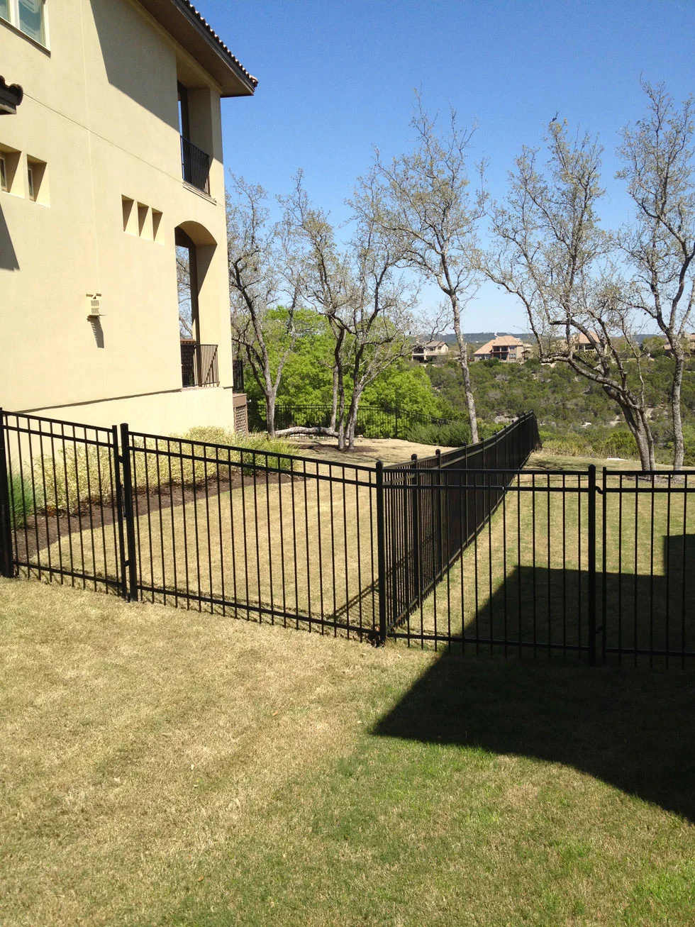 Wrought iron fence and gate built by the B.C. Fence crew in Central Texas