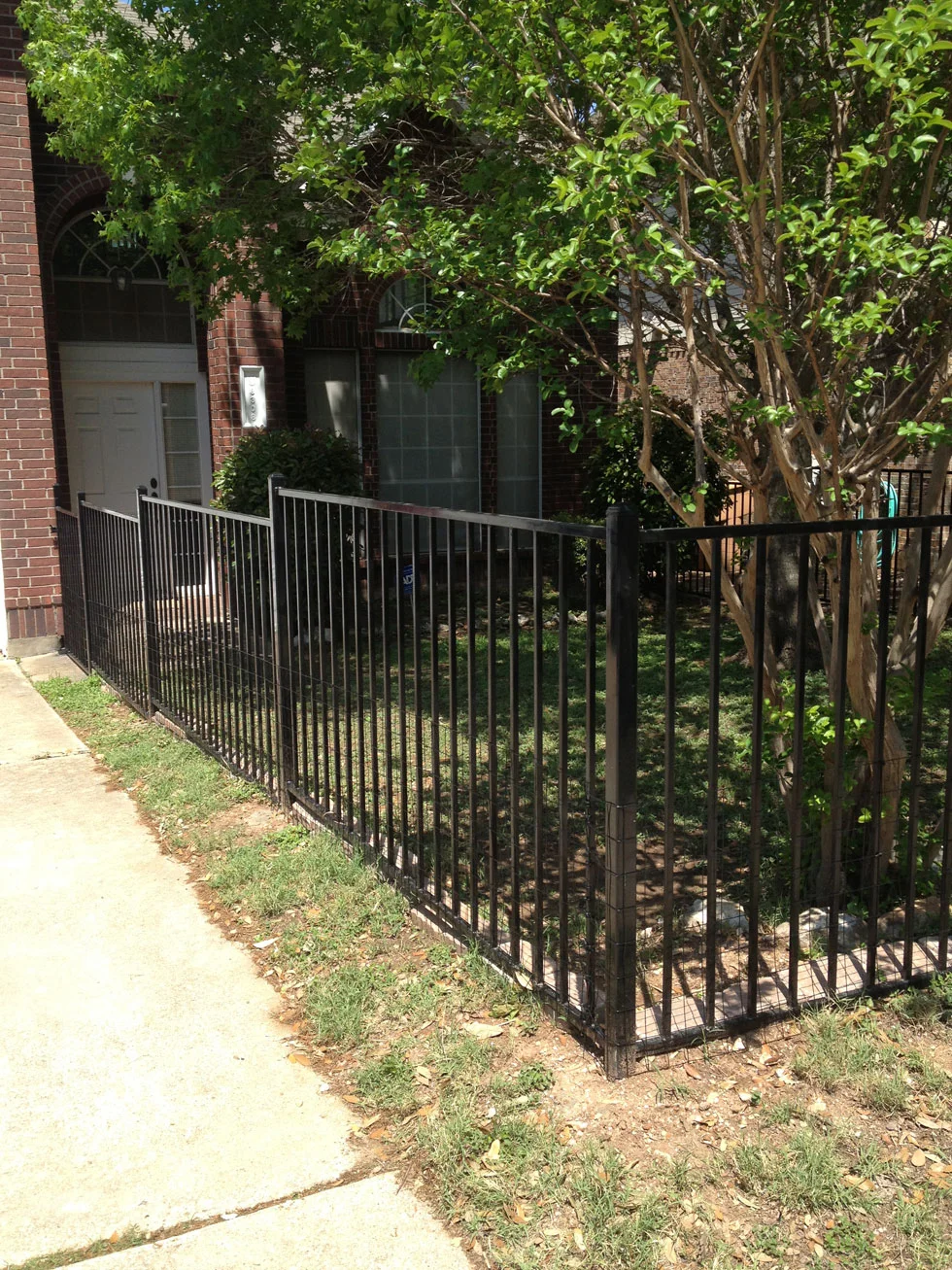 Iron fence line completed by B.C. Fence on an Austin-area property
